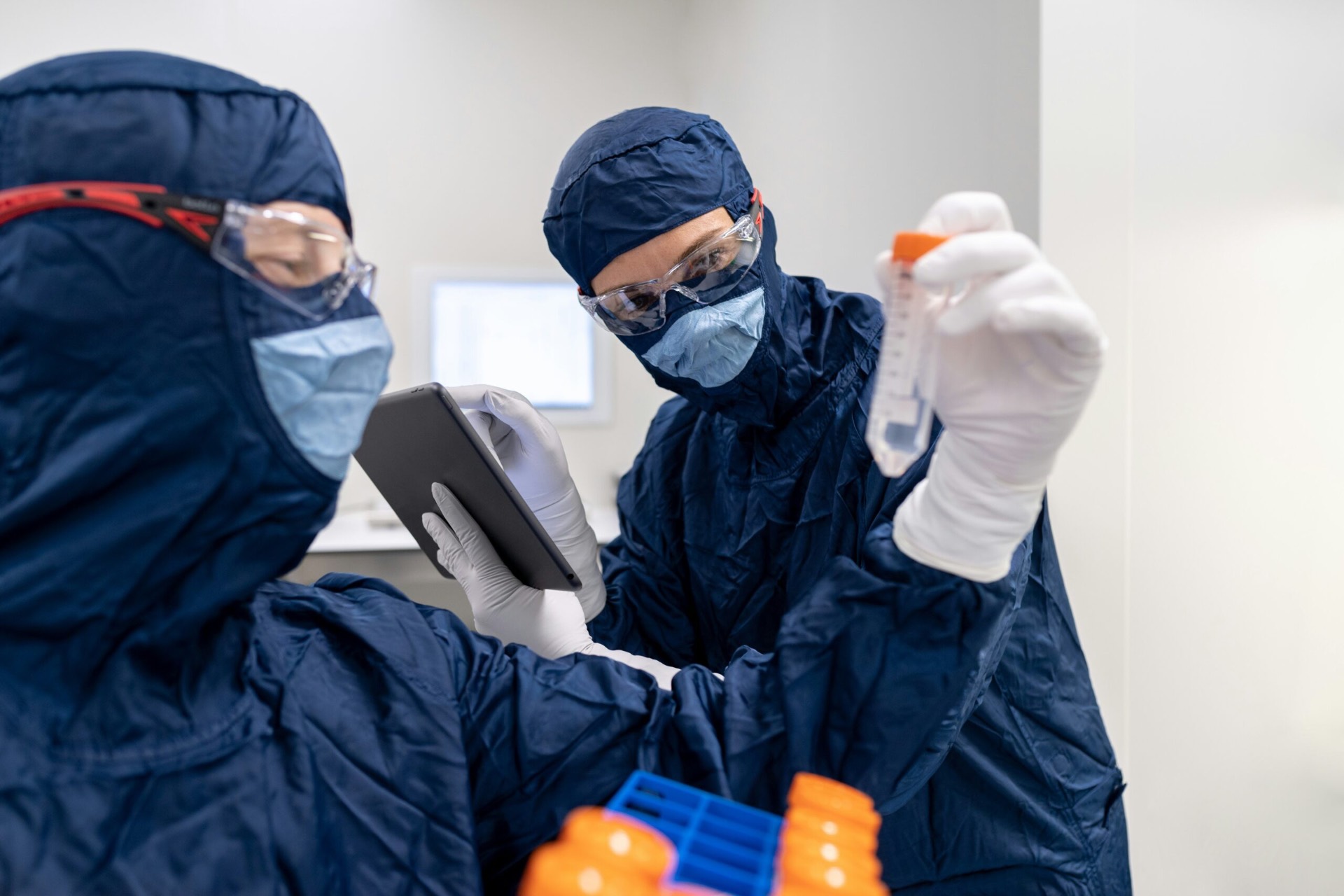 Research scientists in a controlled laboratory environment performing peptide analysis